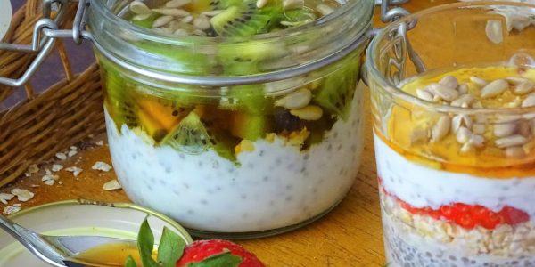 Delicious chia seed parfaits topped with fresh kiwi, strawberries, and sunflower seeds.