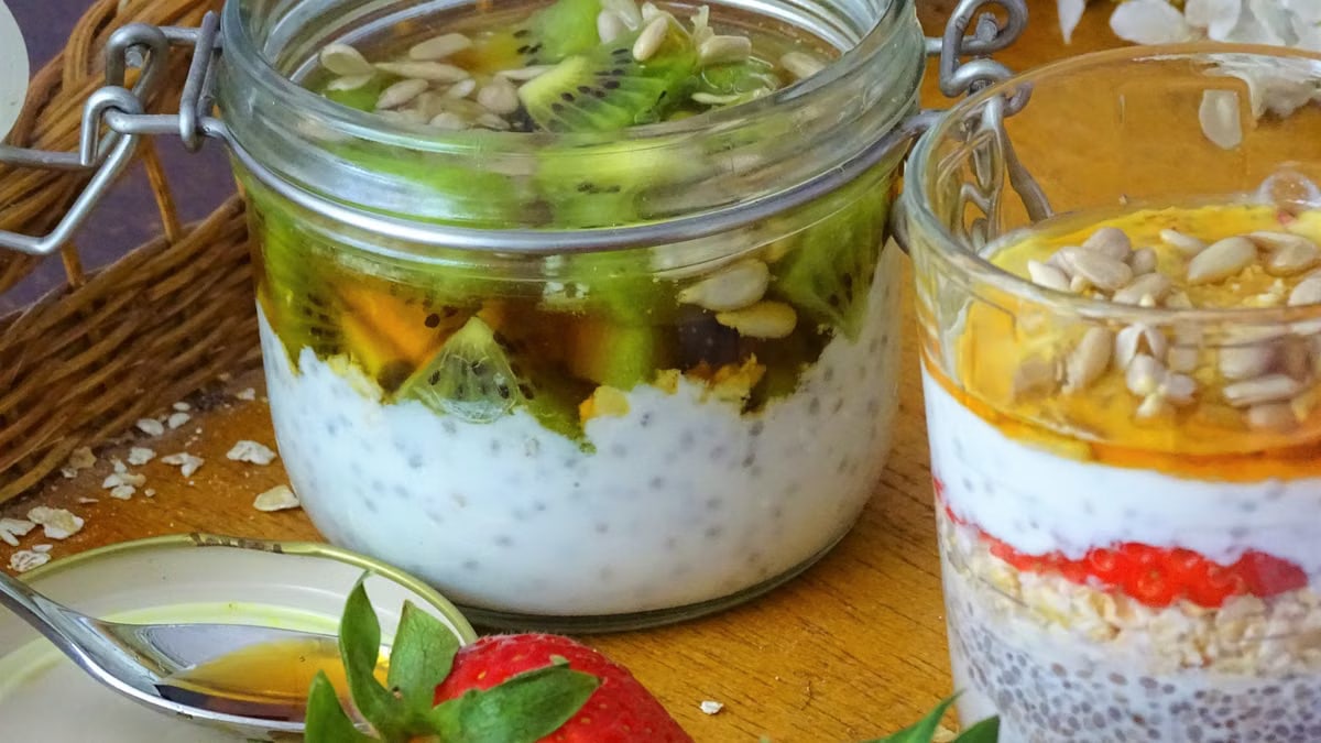 Delicious chia seed parfaits topped with fresh kiwi, strawberries, and sunflower seeds.